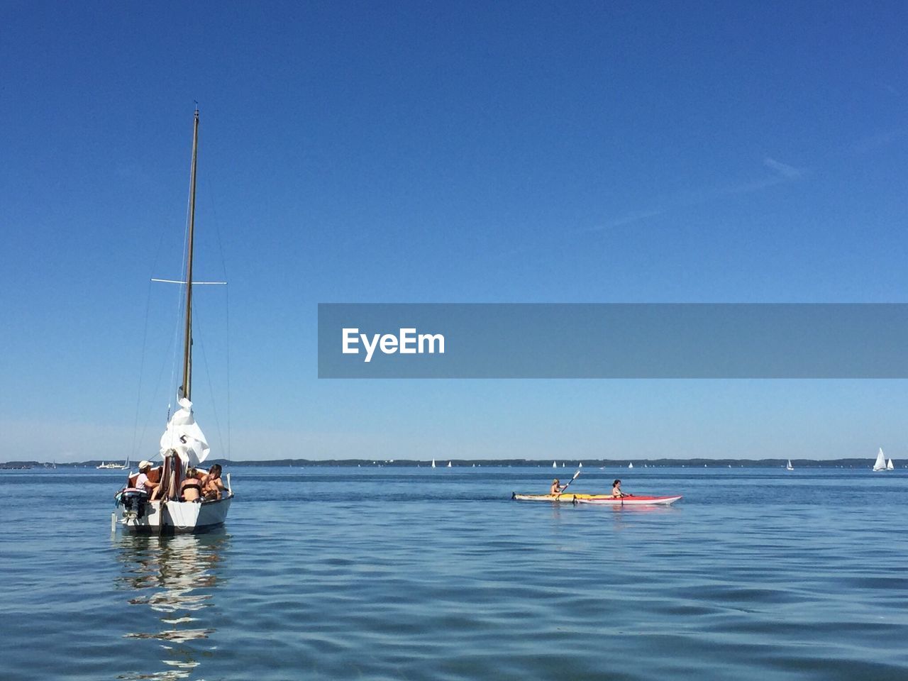 Sailboat sailing on sea against clear sky