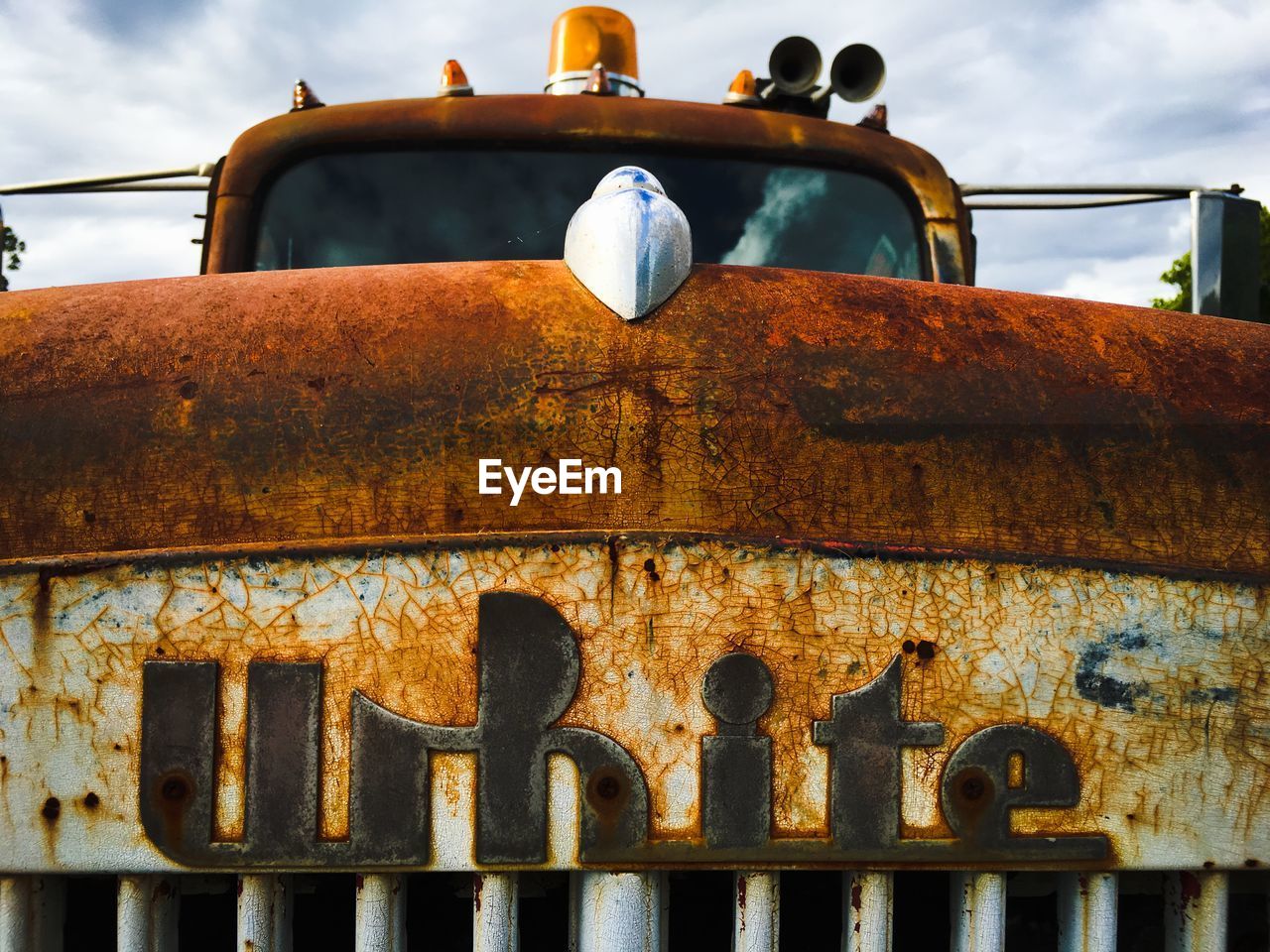 Abandoned rusty car against sky