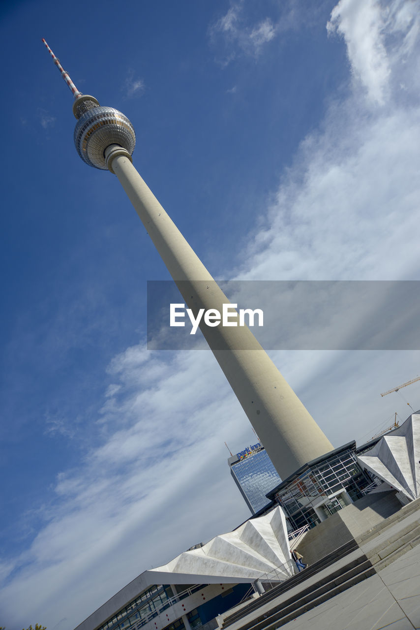 LOW ANGLE VIEW OF COMMUNICATIONS TOWER AGAINST CLOUDY SKY
