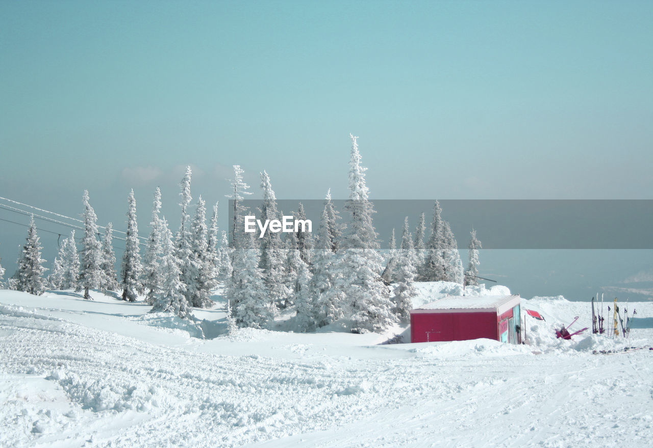 Snow covered land against sky