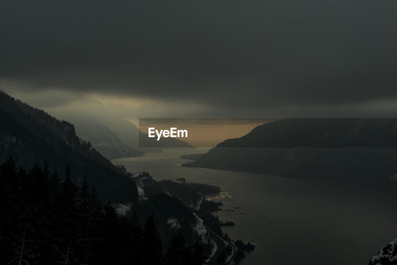 The columbia river winds through the columbia gorge at night.