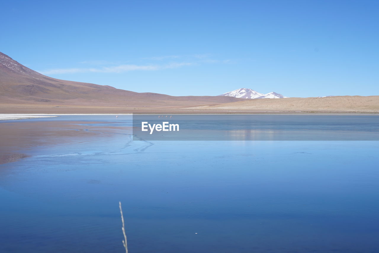 SCENIC VIEW OF LAKE WITH MOUNTAIN IN BACKGROUND