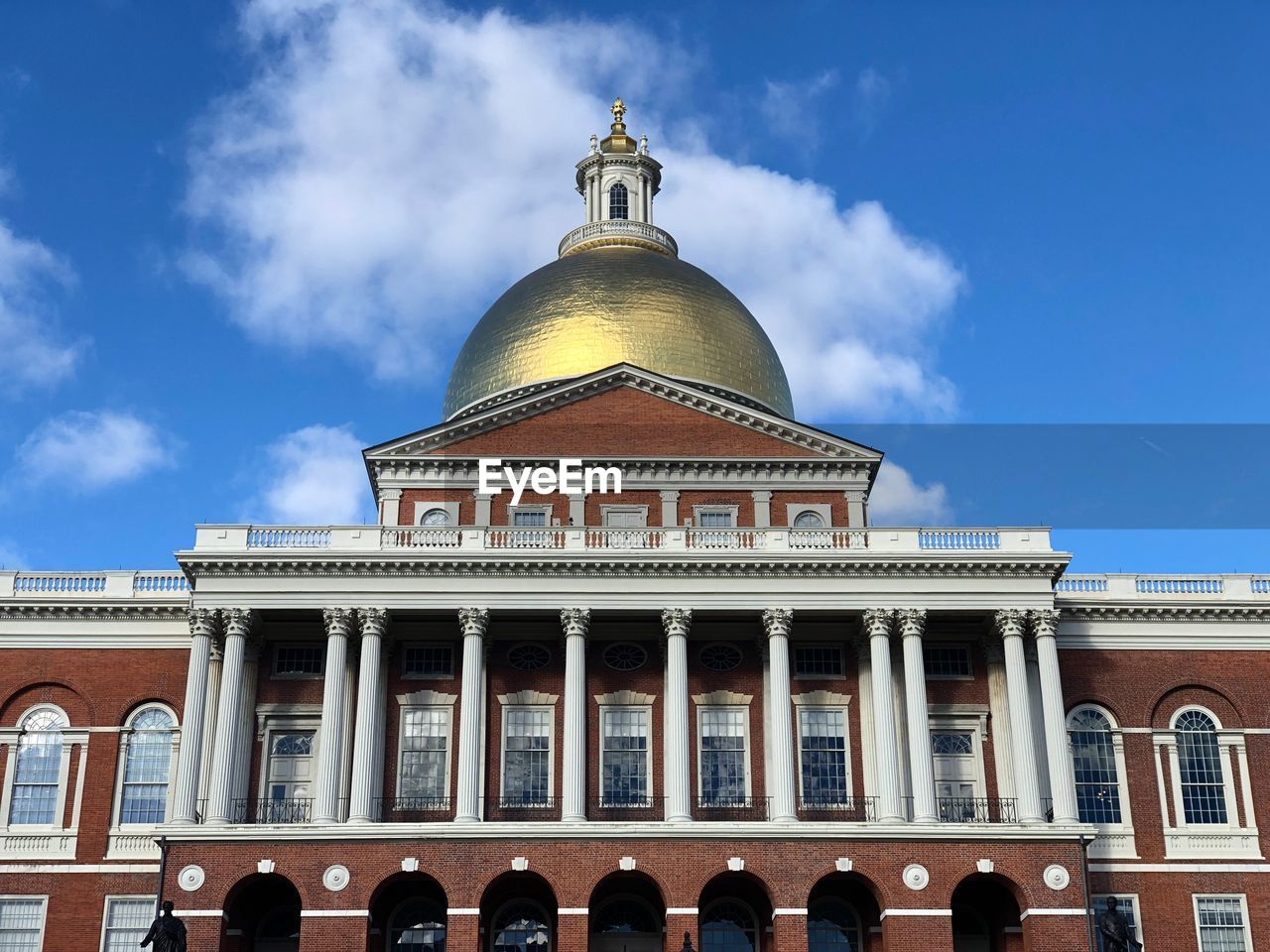 Low angle view of building against cloudy sky