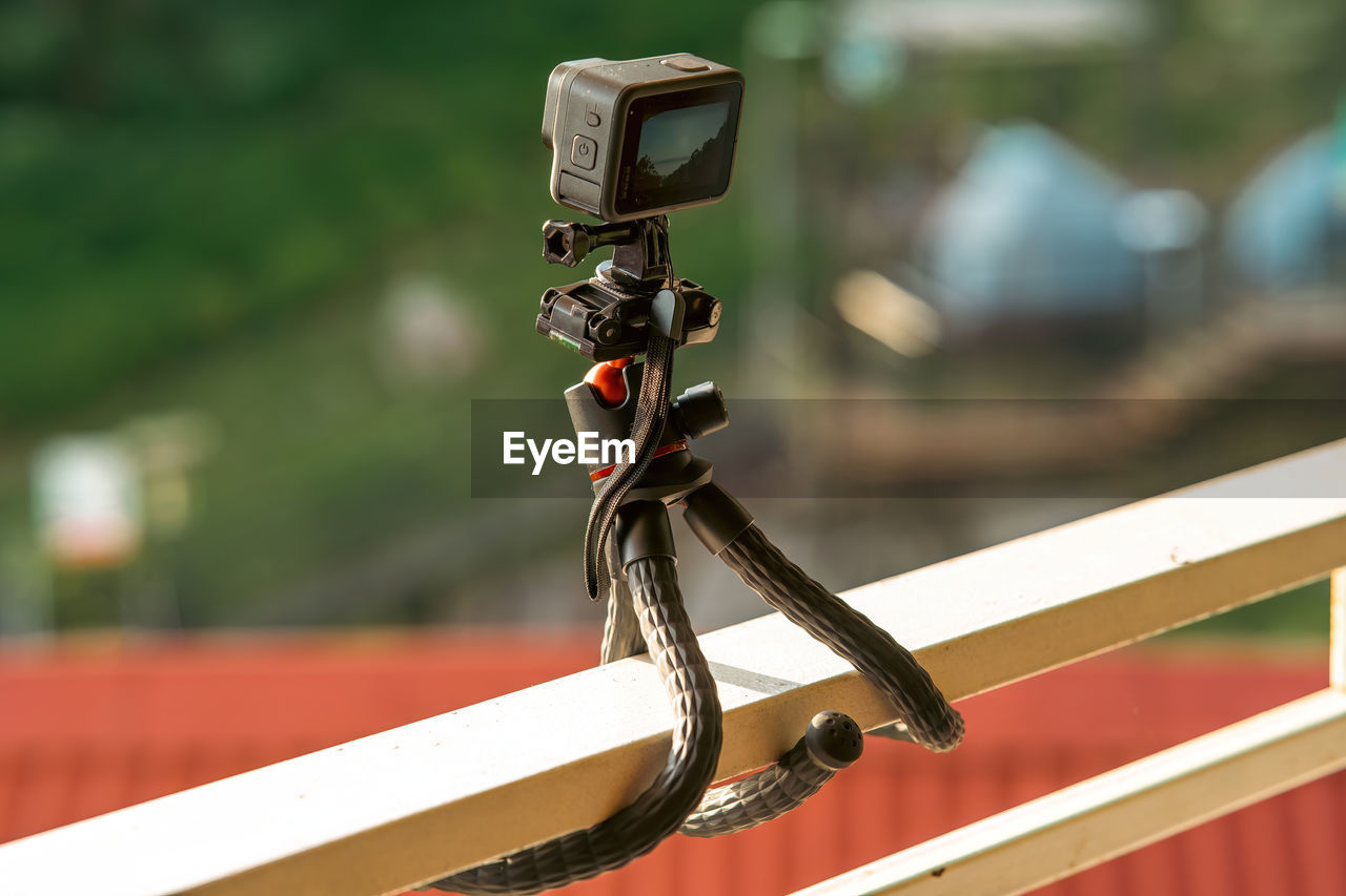 Action camera on tripod capturing time-lapsed video.