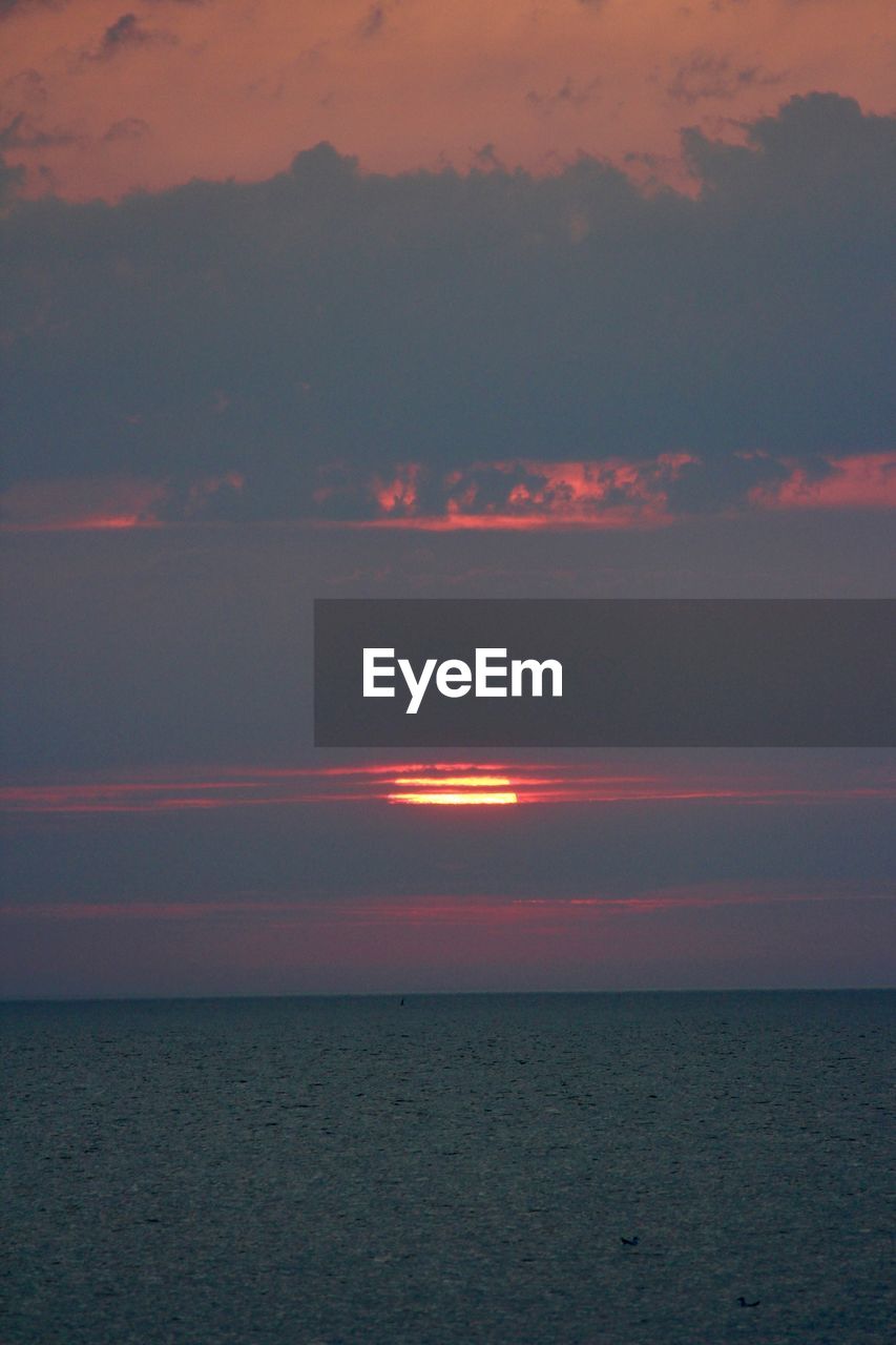 SCENIC VIEW OF SUNSET OVER SEA