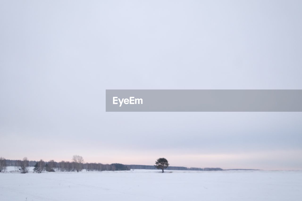 Scenic view of snow covered field against clear sky