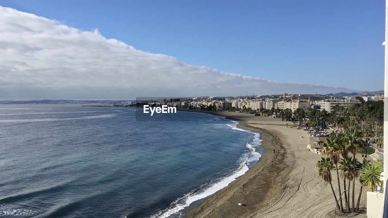 Panoramic view of sea and buildings against sky