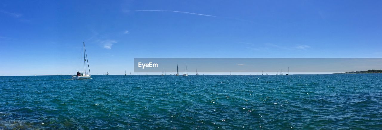 Lone boat in calm blue sea against sky