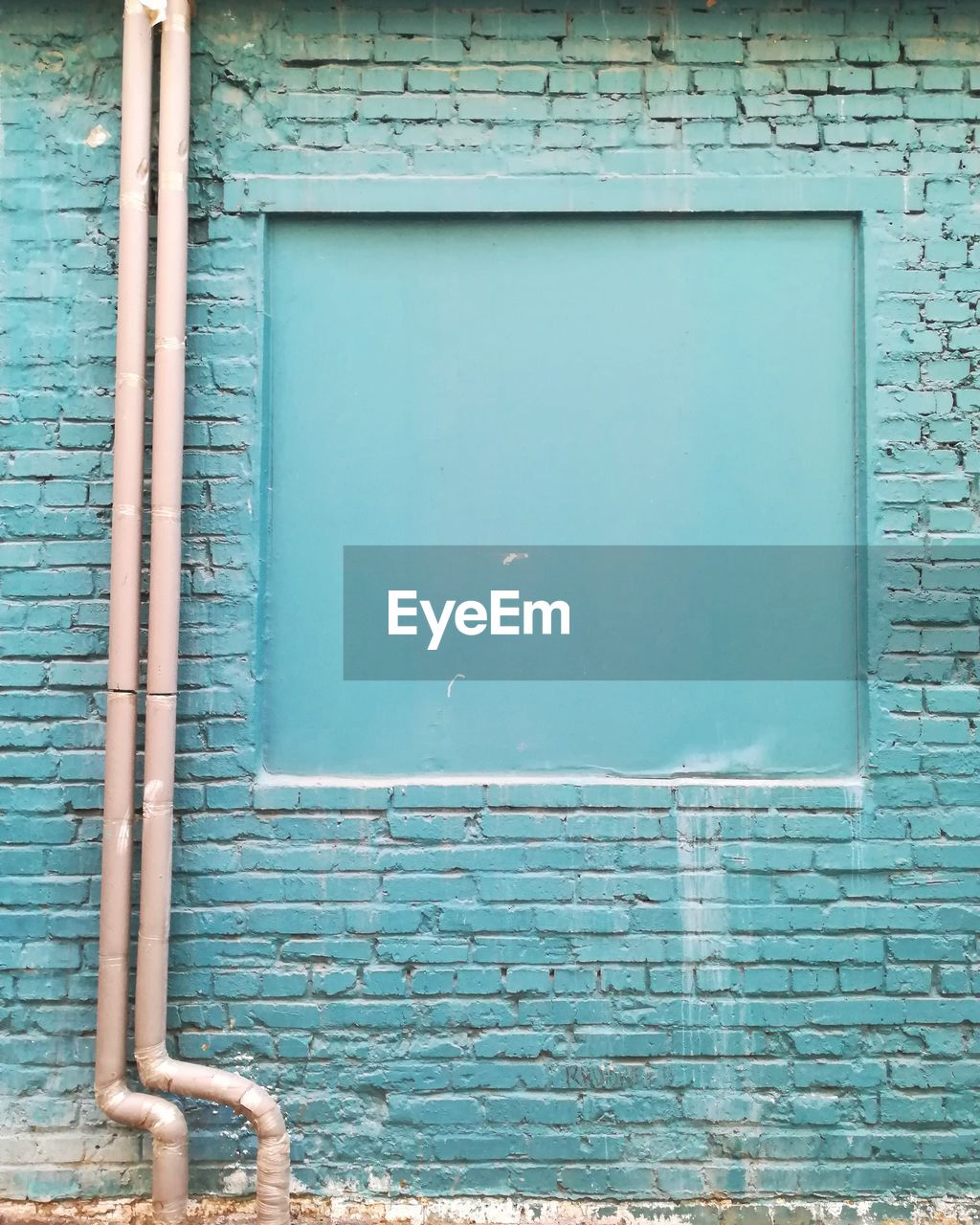 Low angle view of blue window on wall of building