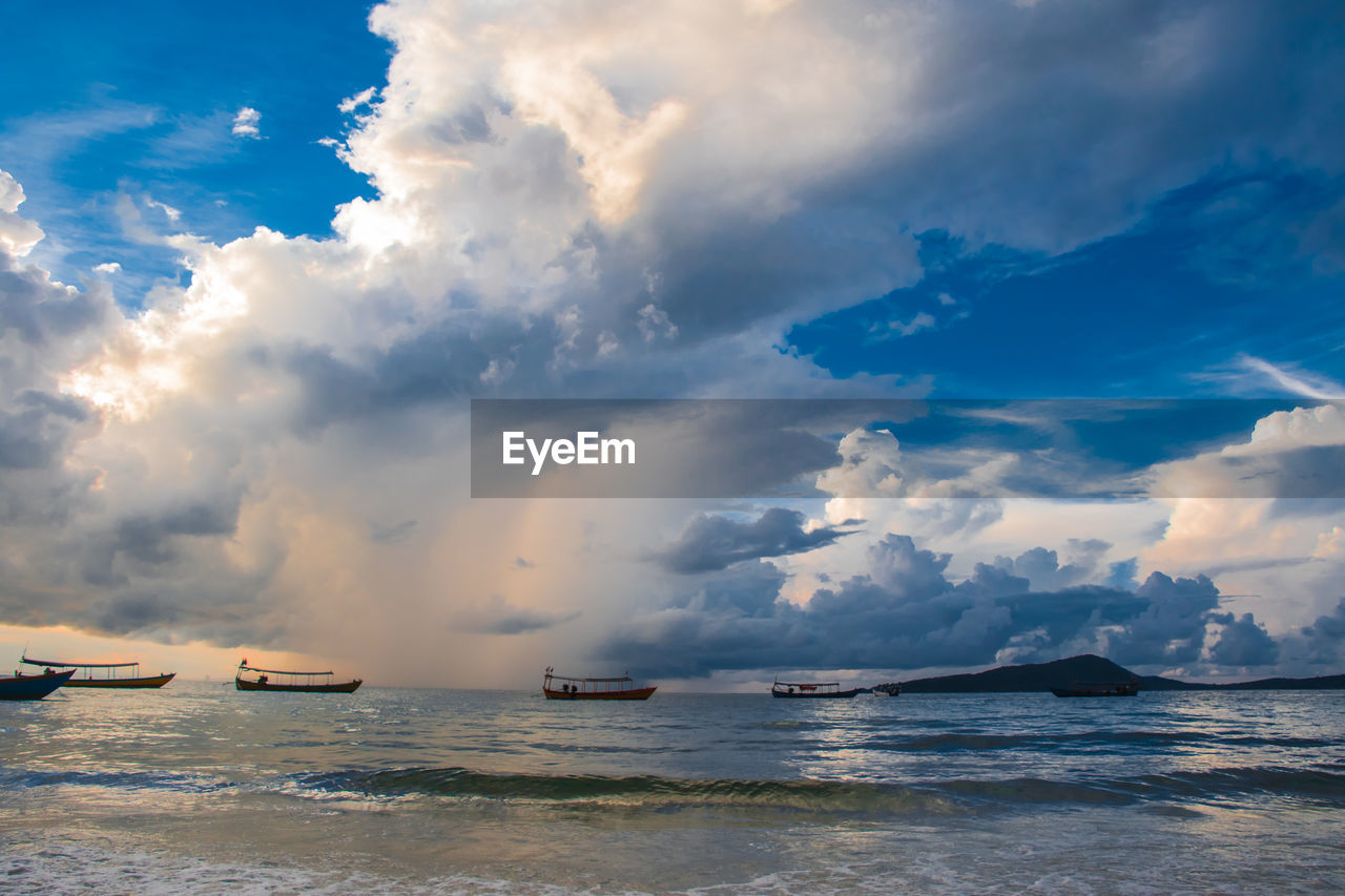 Koh rong island, cambodia at sunrise. strong vibrant colors, boats and ocean