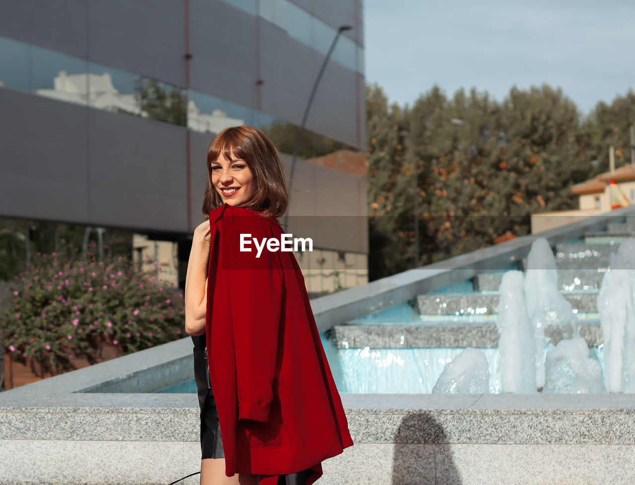 Portrait of smiling young woman standing outdoors