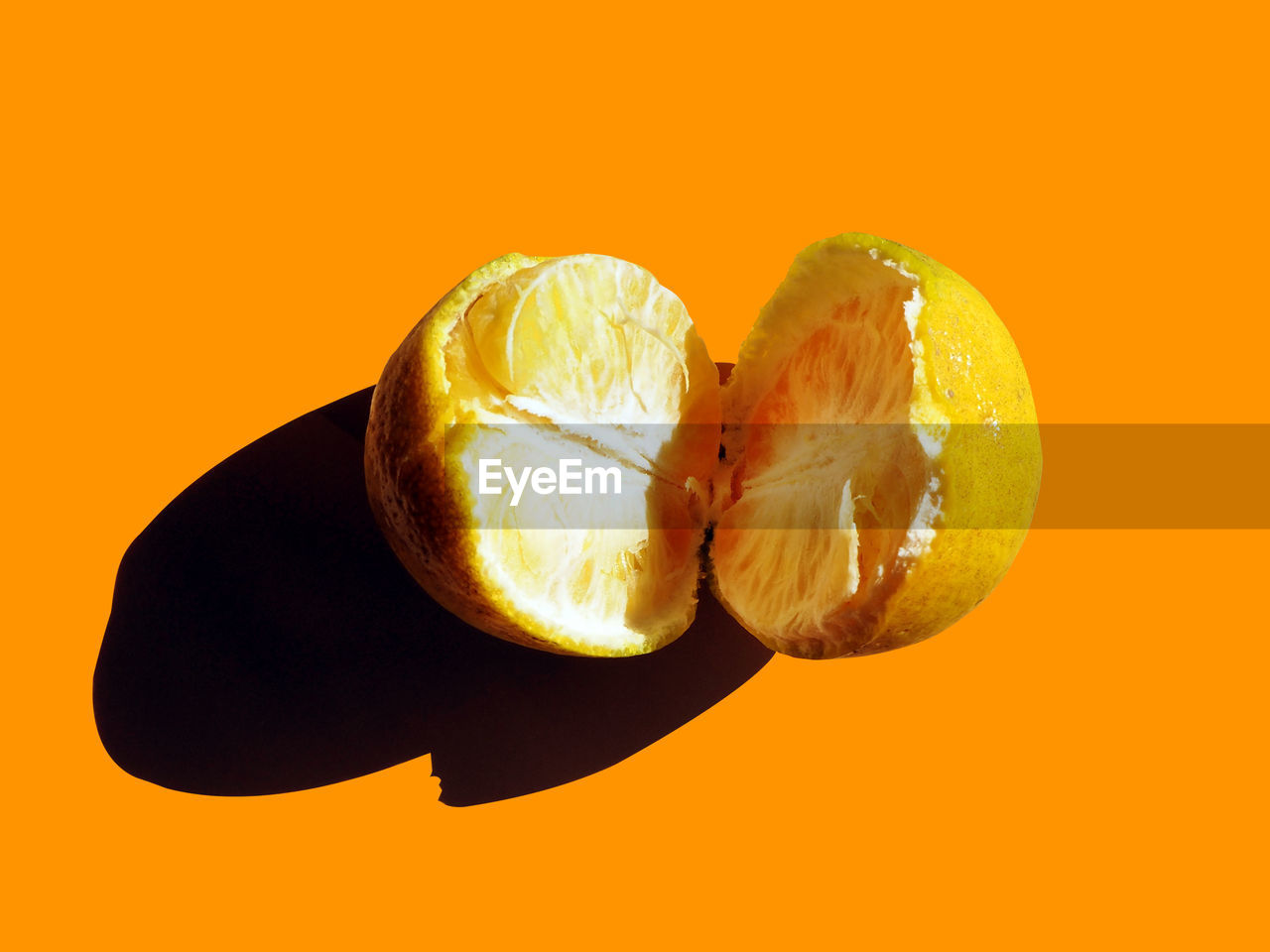 CLOSE-UP OF ORANGE SLICE OVER YELLOW BACKGROUND