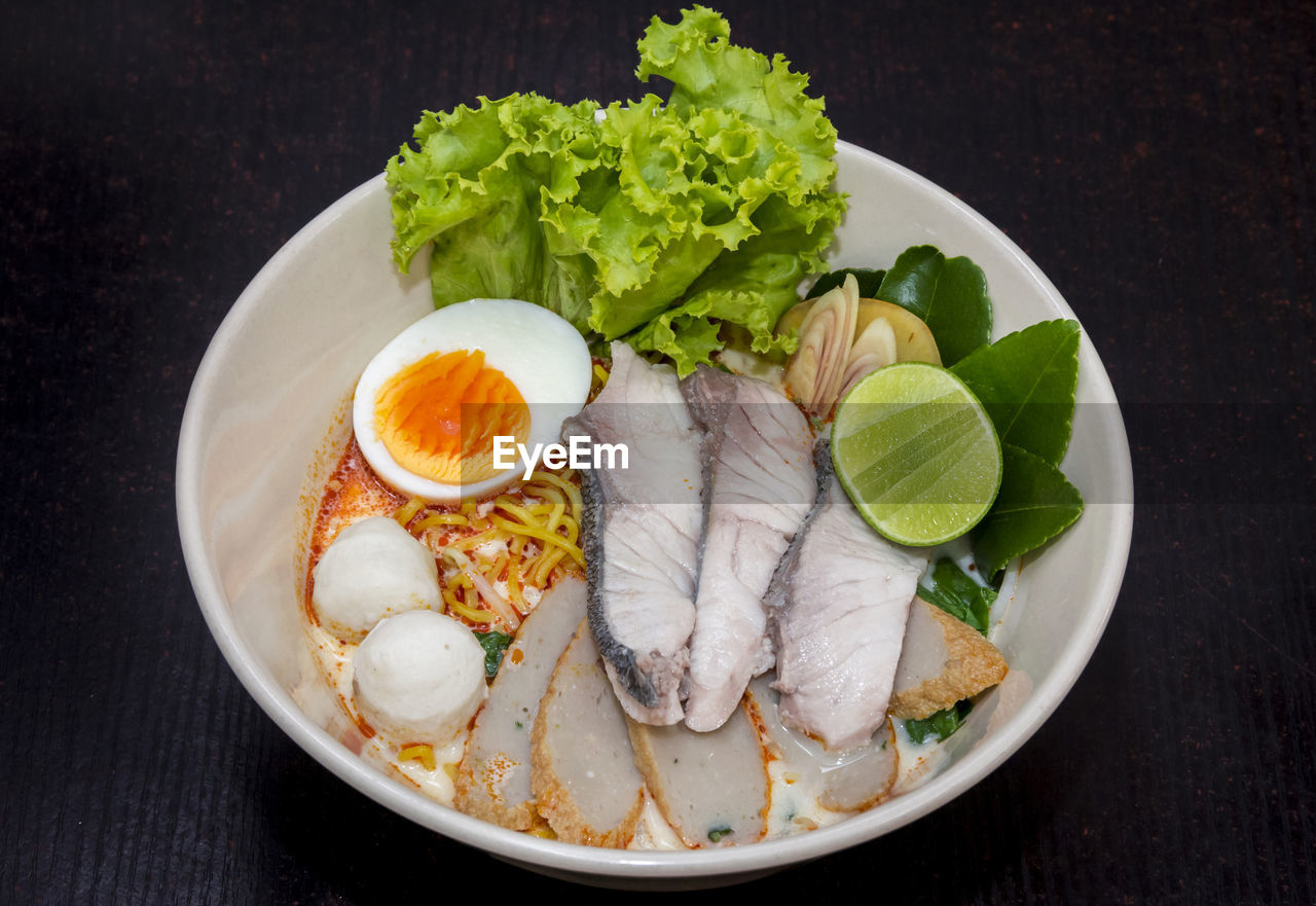 CLOSE-UP OF SEAFOOD SERVED ON TABLE