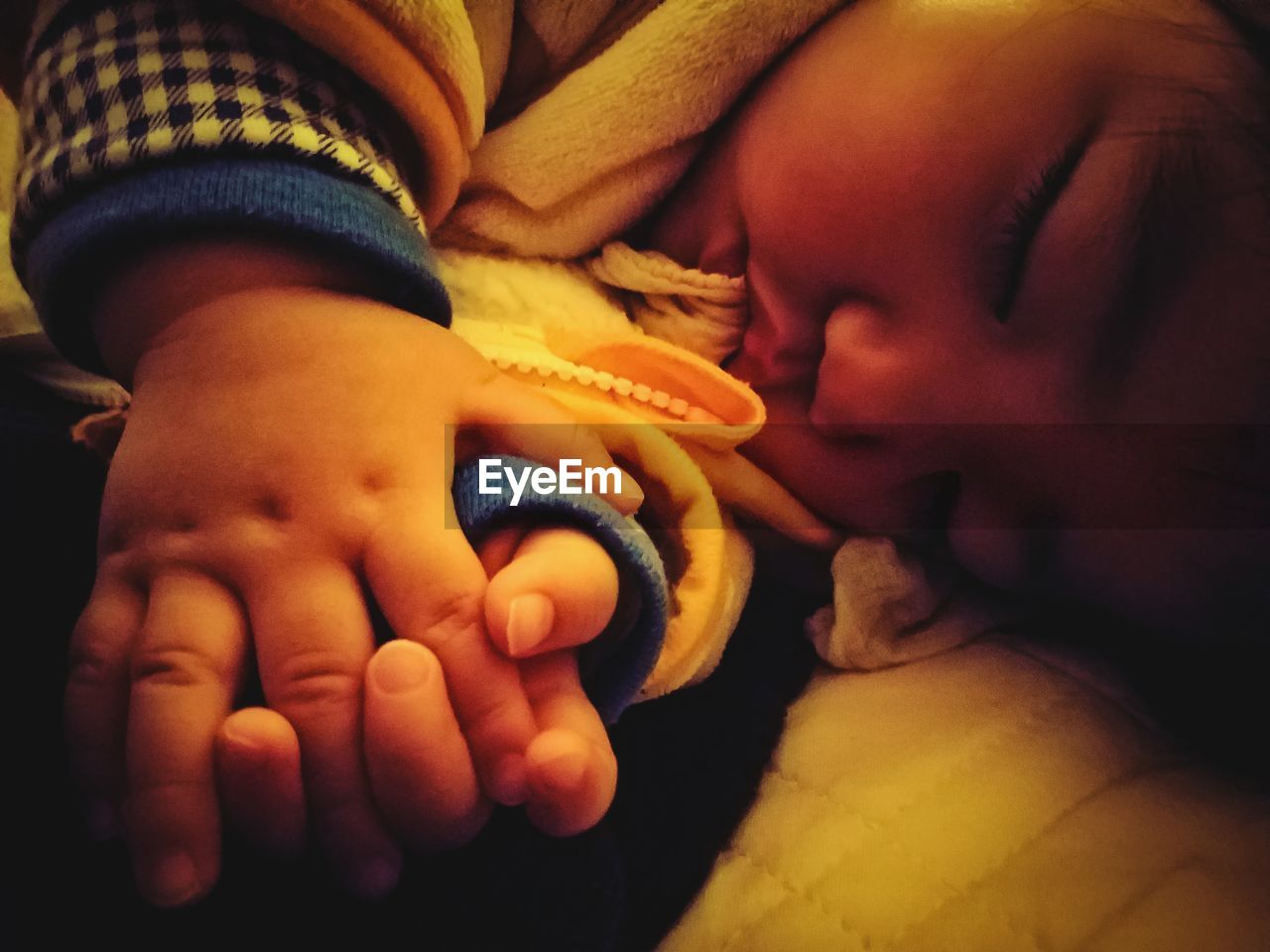 CLOSE-UP OF BABY GIRL WITH HANDS