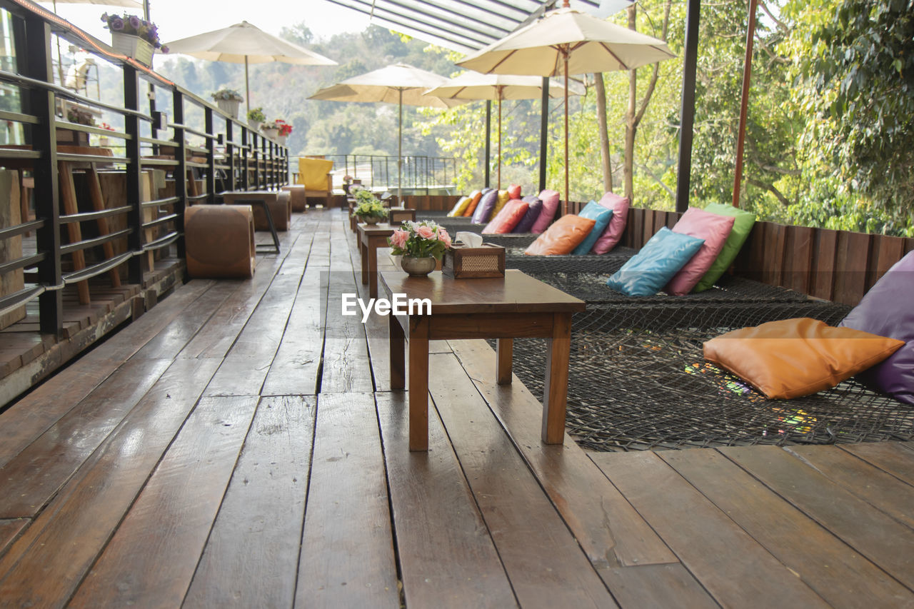 EMPTY CHAIRS AND TABLES AT SIDEWALK