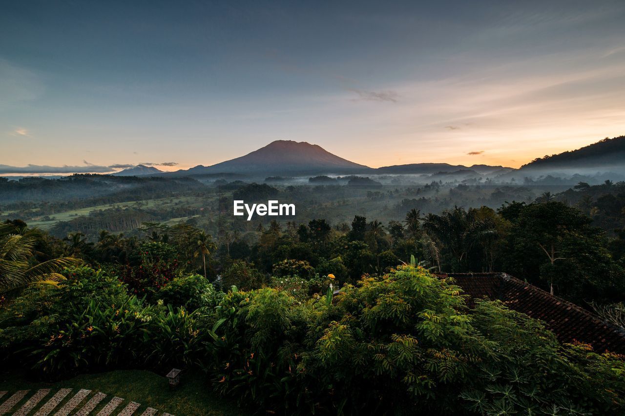 Scenic view of mountains against sky at sunset