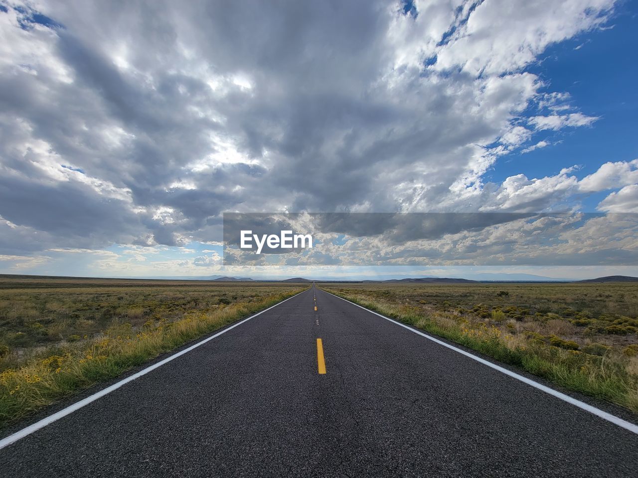 ROAD AMIDST LANDSCAPE AGAINST SKY