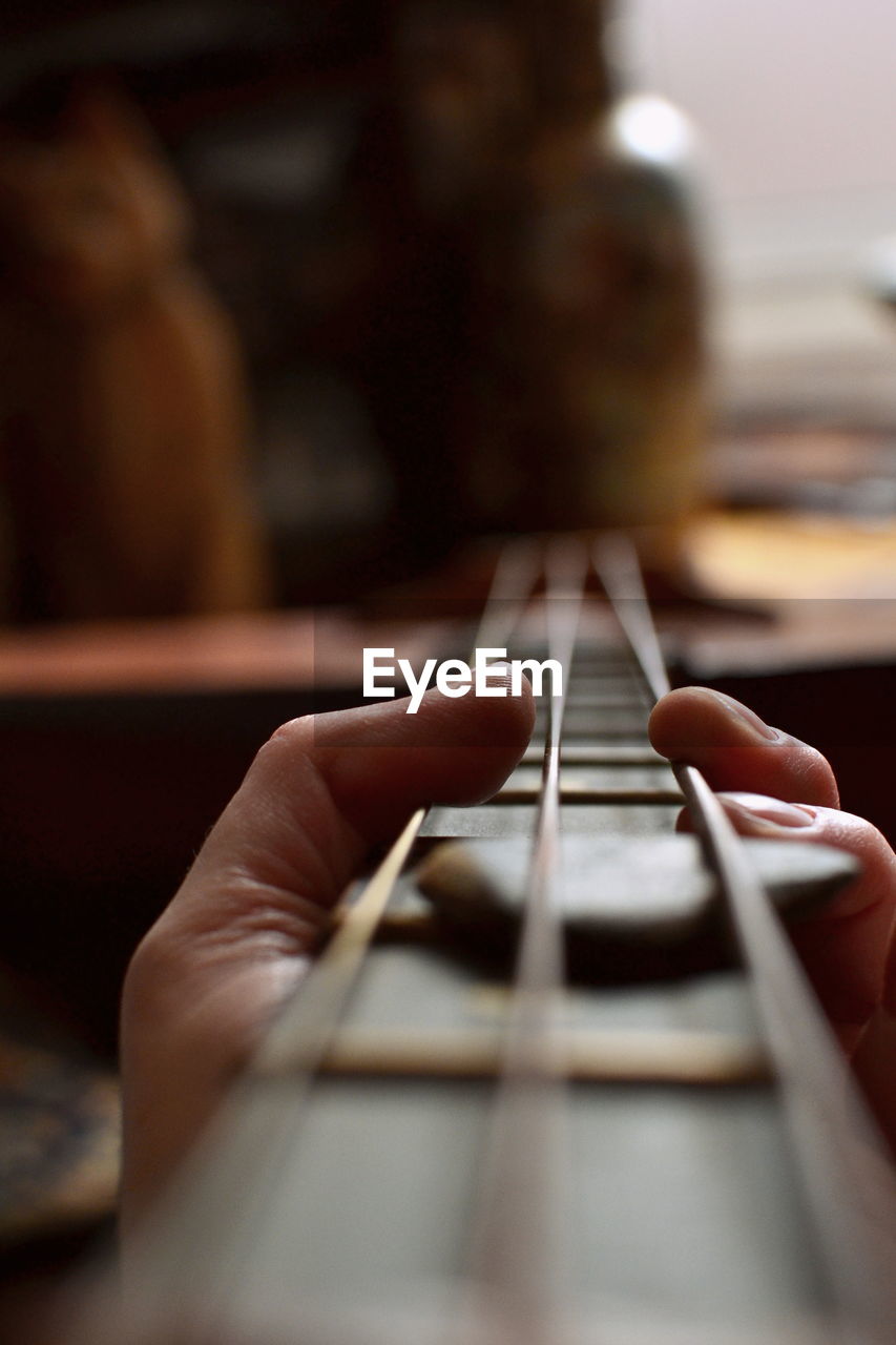 Close-up of hand playing guitar