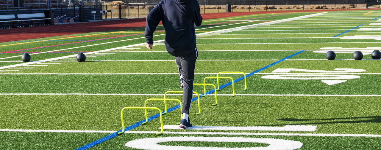 Low section of man running on grassland