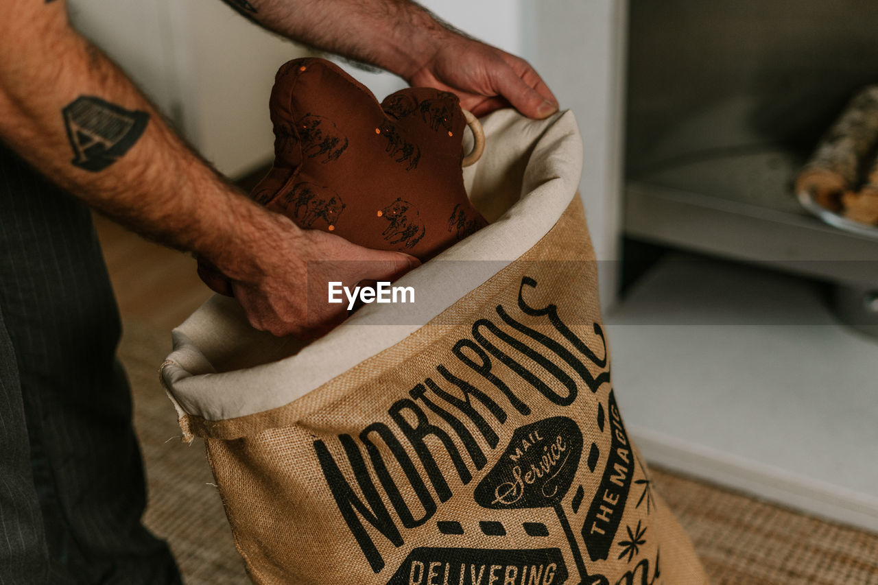 cropped hand of man holding gift