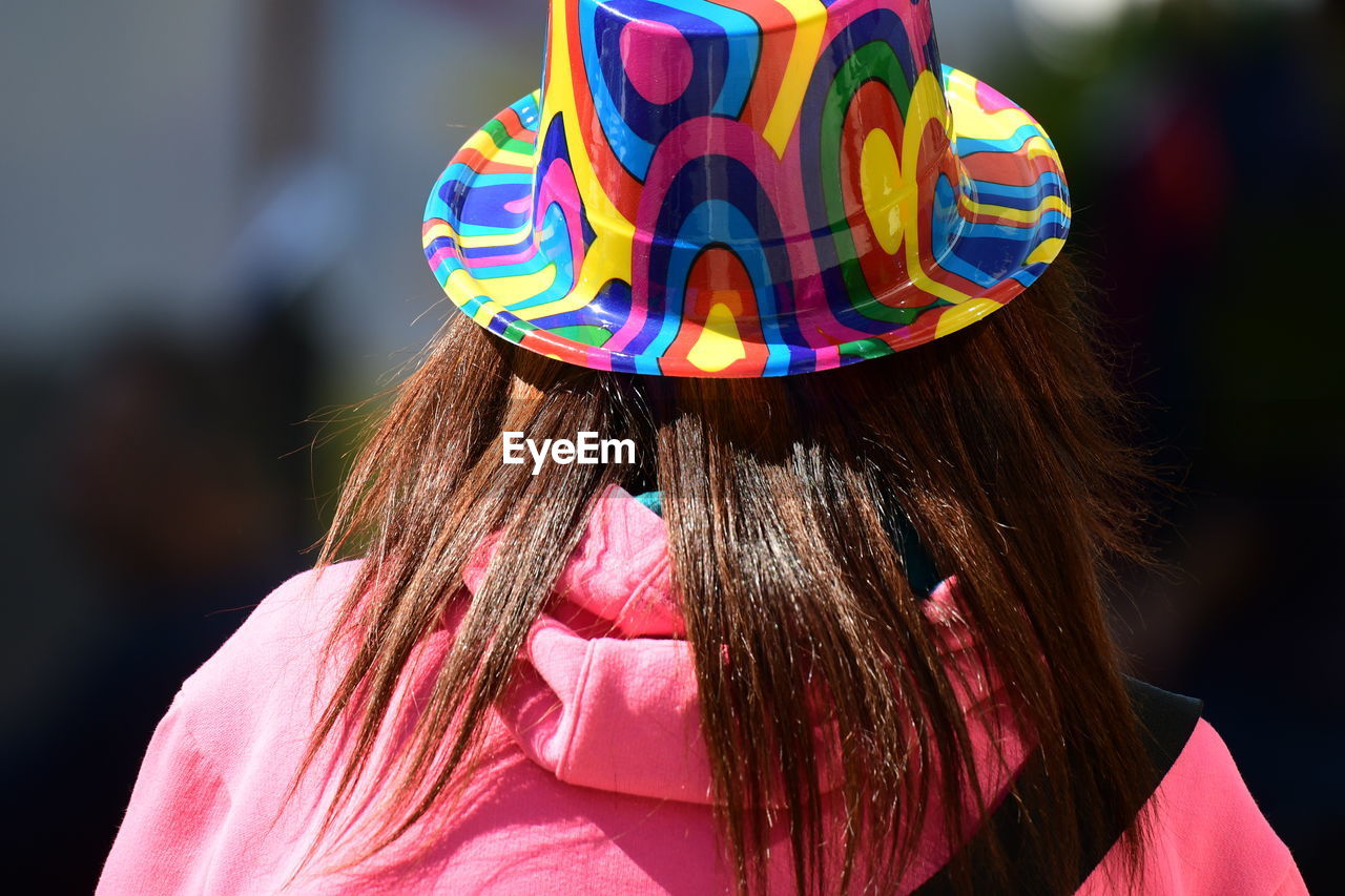 REAR VIEW OF WOMAN WITH COLORFUL UMBRELLA