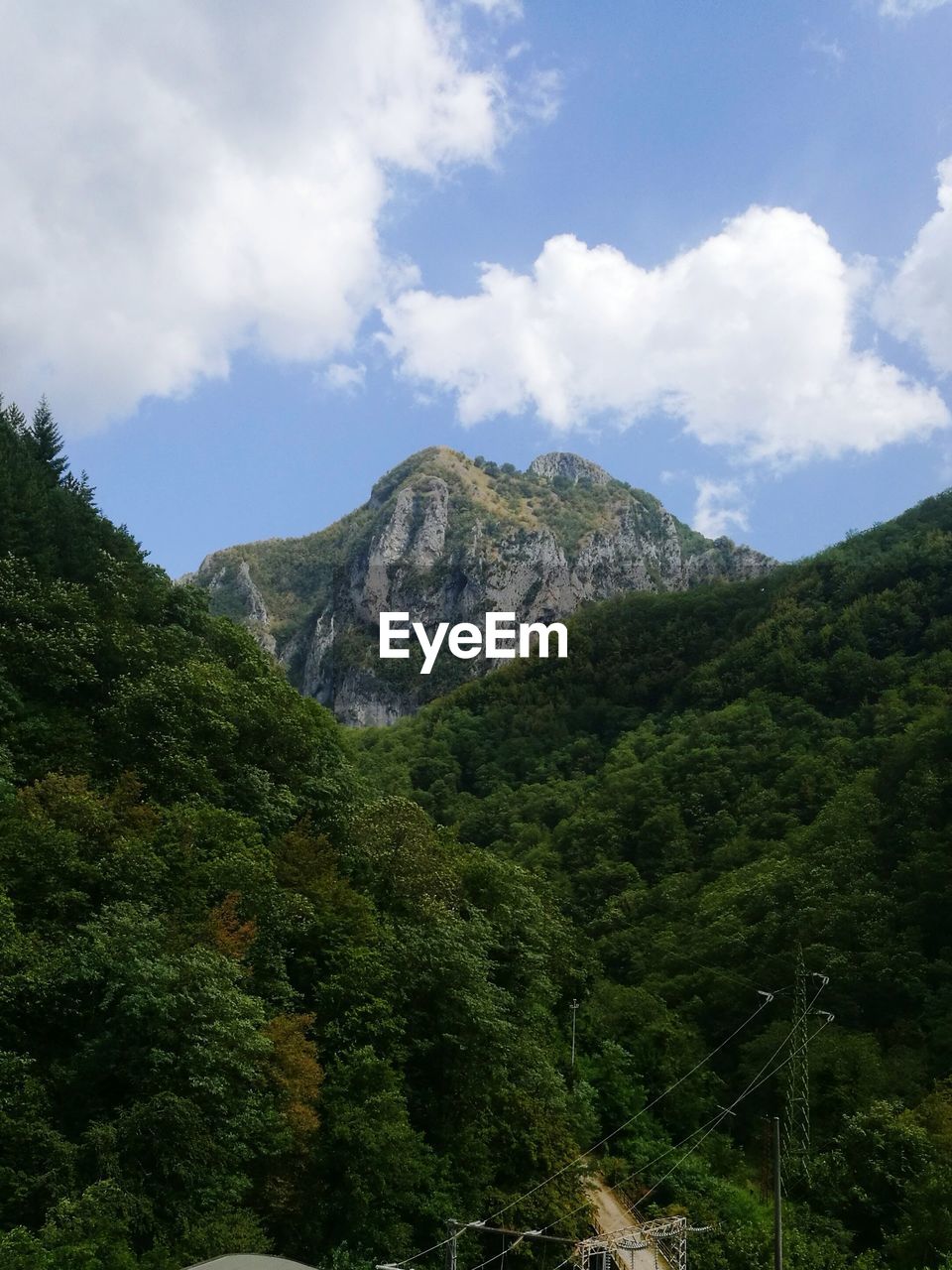 Low angle view of mountain against cloudy sky