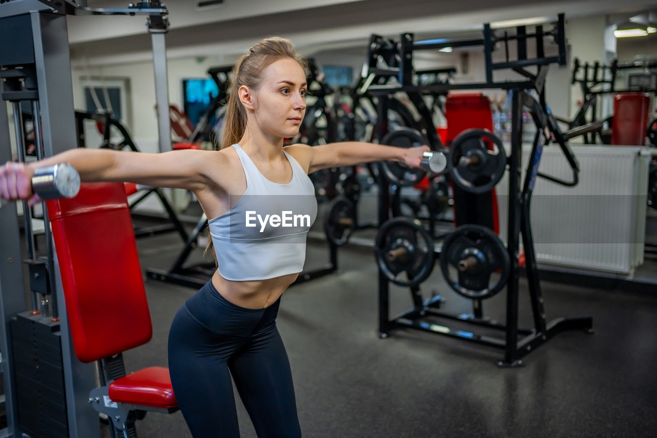 portrait of woman exercising in gym