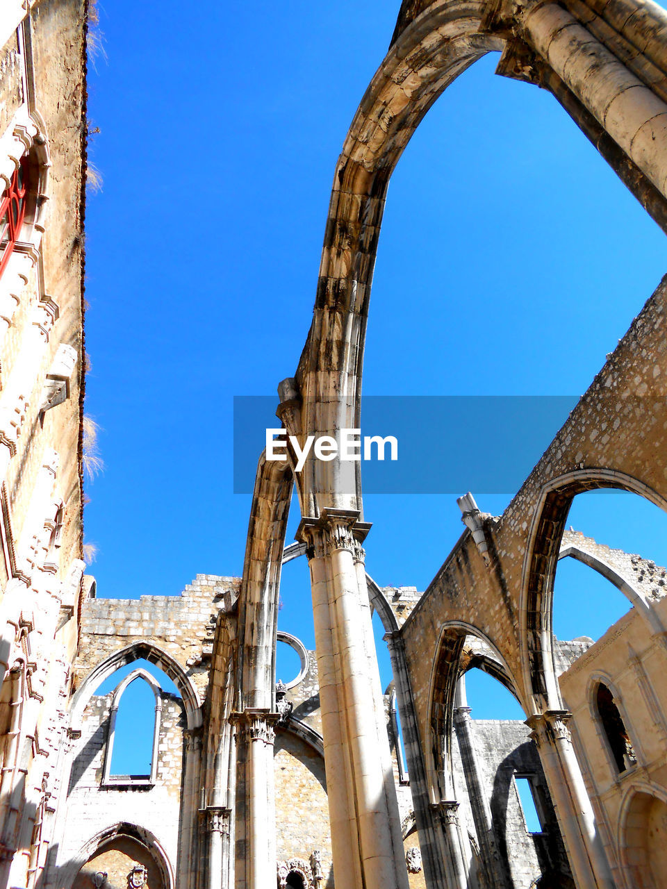 Low angle view of old ruins against clear blue sky. carmo convent lisbon portugal