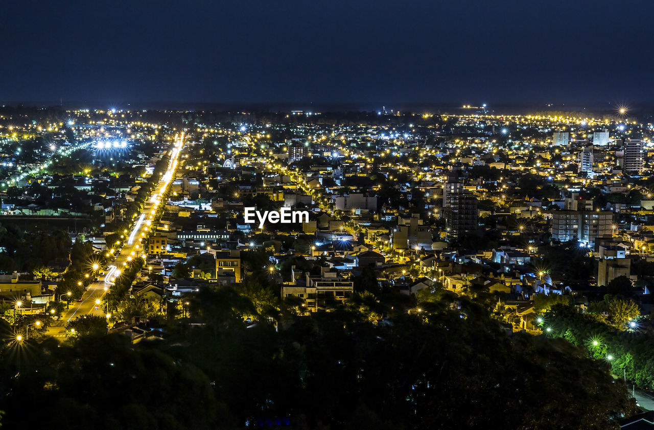 High angle view of illuminated buildings in city at night