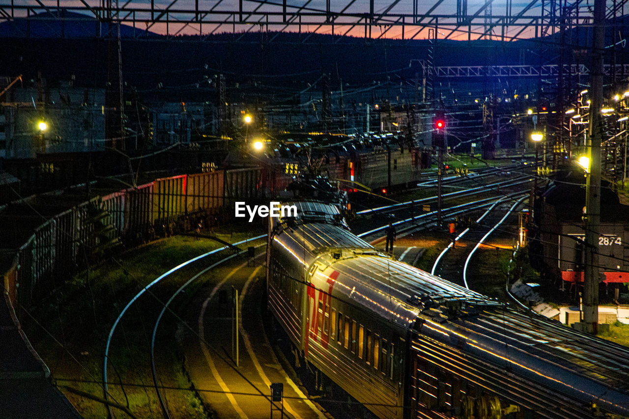 High angle view of railroad tracks in city at night