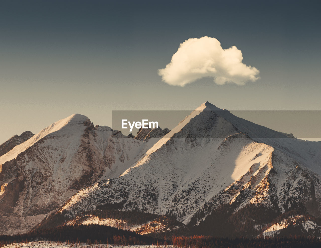 Scenic view of snowcapped mountains against sky during sunset