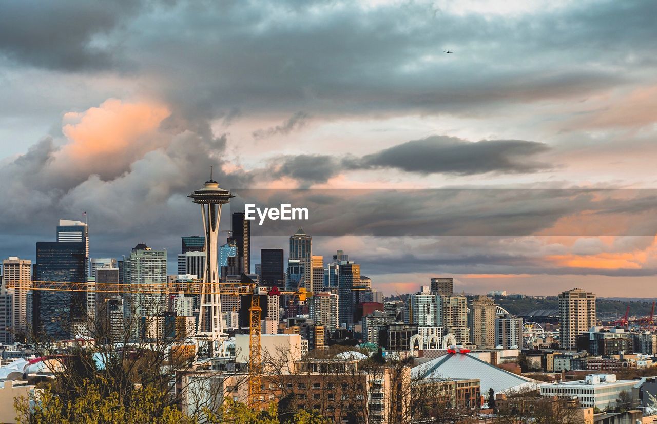 View of cityscape against cloudy sky