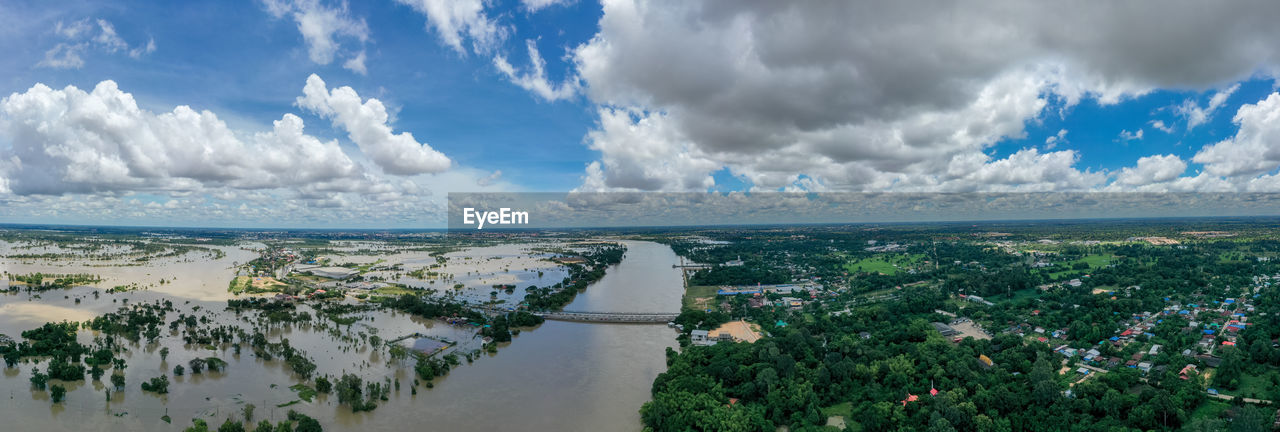 Panoramic view of sea and cityscape against sky