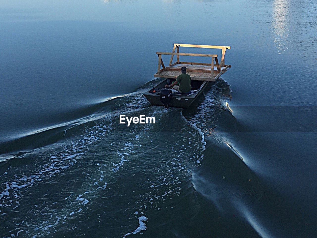 Rear view of man on boat sailing in river