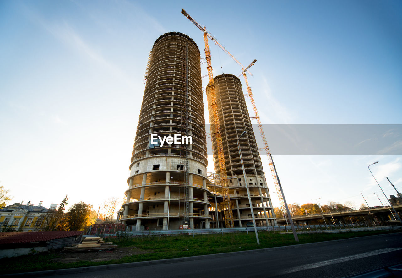 Low angle view of incomplete buildings against sky