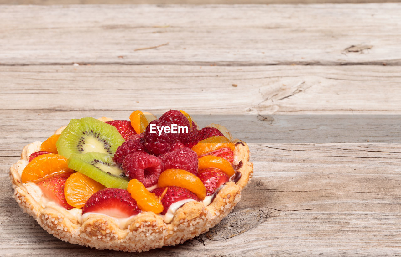 Close-up of fruit tart on wooden table