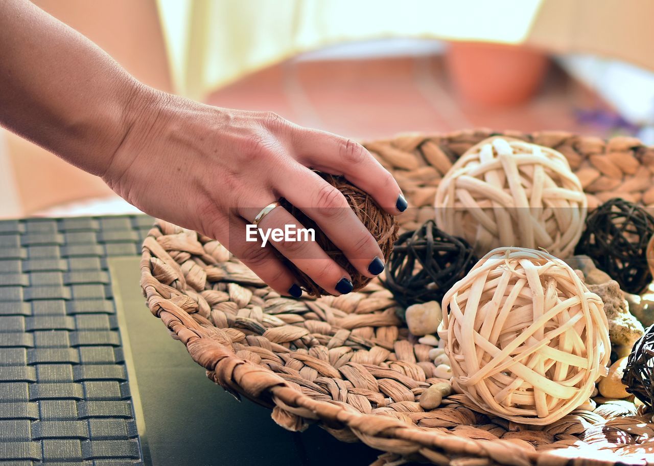 Cropped image of woman keeping object on table