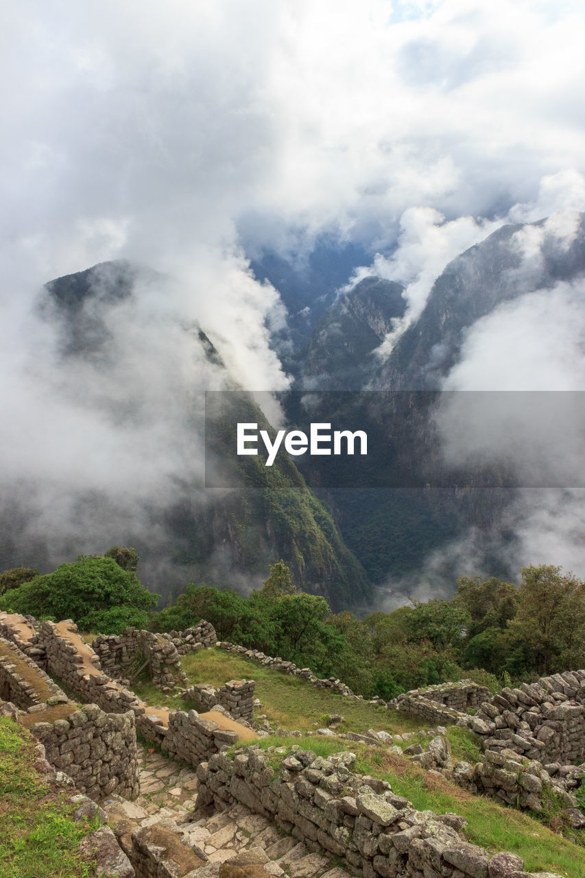SCENIC VIEW OF CLOUDS OVER MOUNTAIN