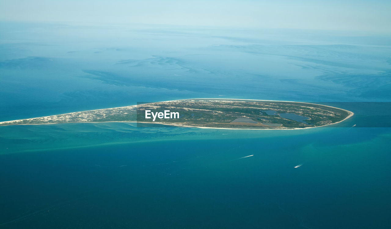 water, sea, horizon, ocean, nature, aerial view, atoll, transportation, scenics - nature, beauty in nature, aerial photography, no people, blue, day, mode of transportation, nautical vessel, travel, outdoors, coast, tranquility, environment, high angle view, land, tranquil scene, wave, sky, airplane, travel destinations, air vehicle, sports