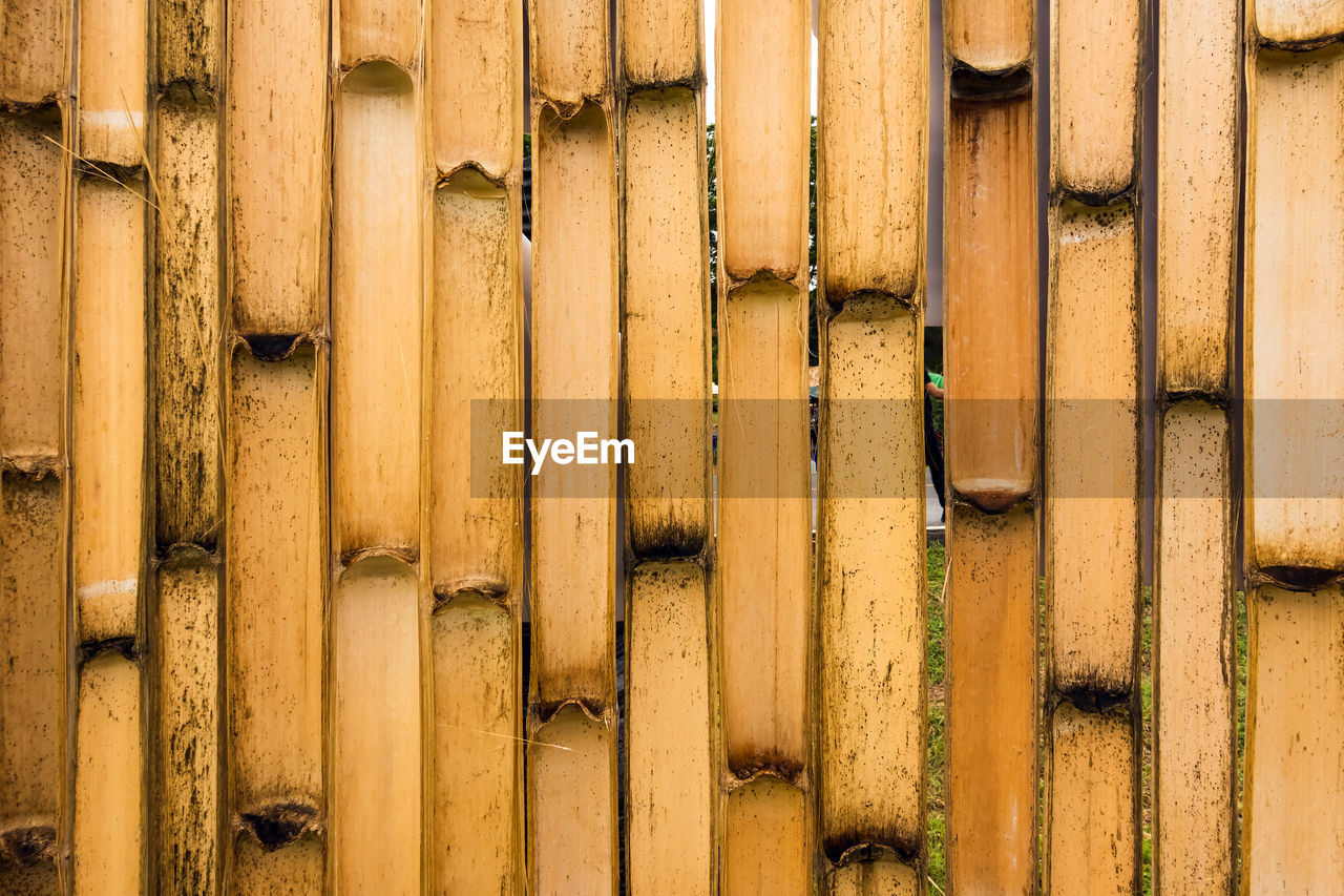 Old brown tone bamboo simple wall or bamboo fence texture background for  design vintage tone. 