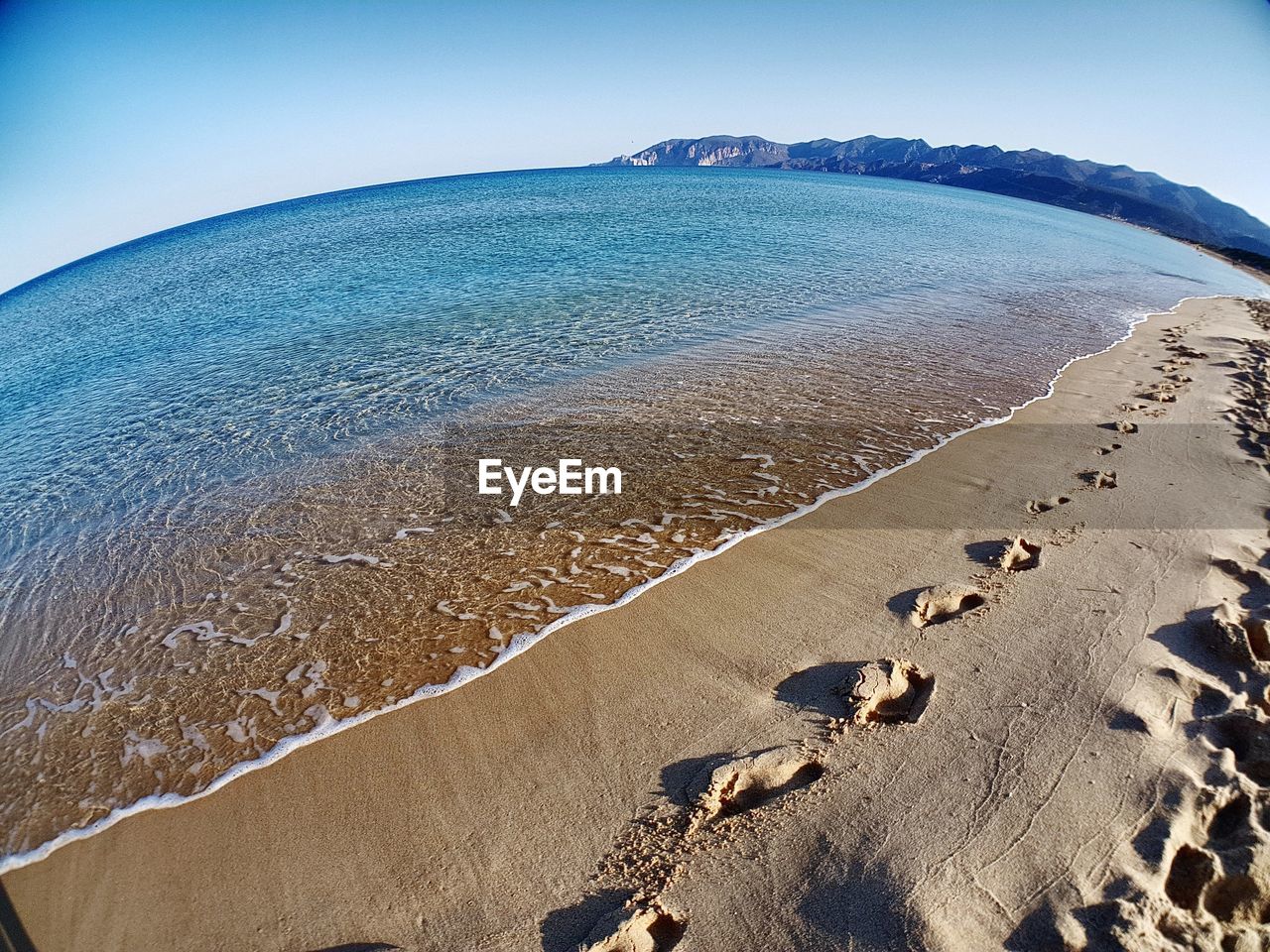 Scenic view of beach against clear sky