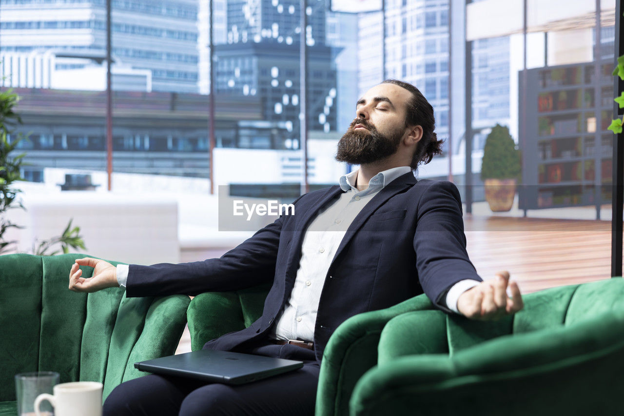 side view of businessman using mobile phone
