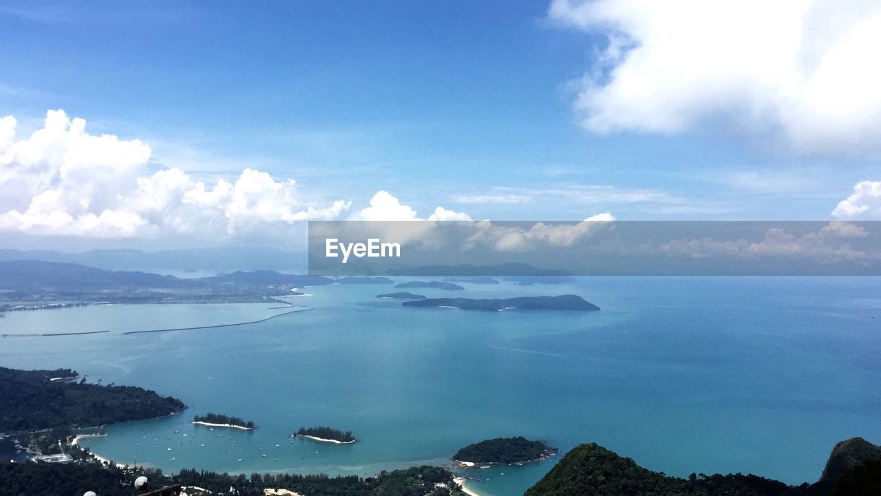 Aerial view of sea and mountains against sky