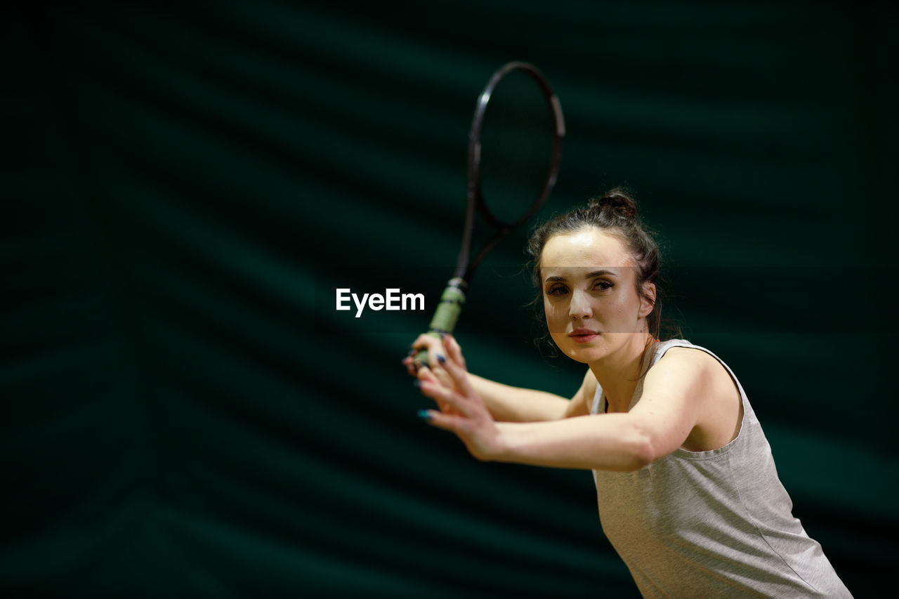 Tennis player playing at court