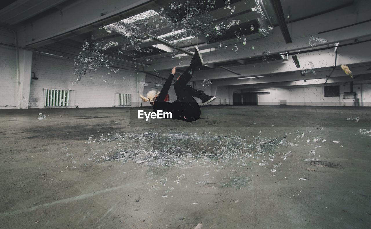 Mid adult woman jumping in parking garage