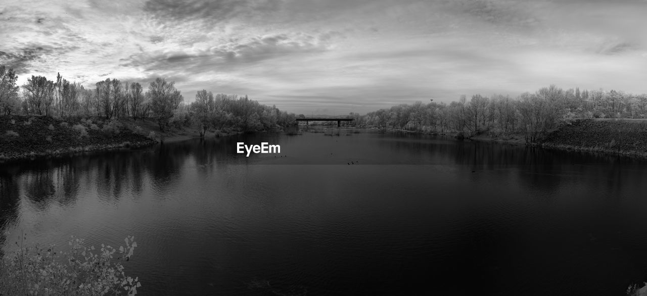 LAKE BY TREES AGAINST SKY