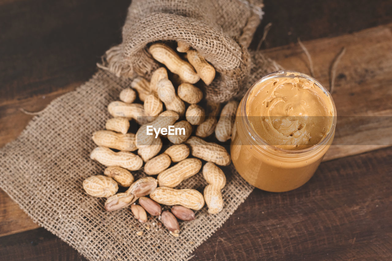 High angle view of peanut butter with groundnut on table