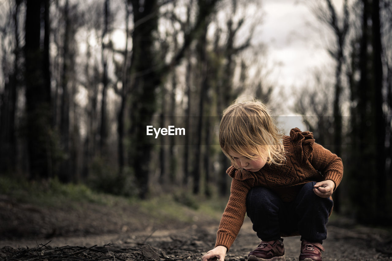 tree, forest, childhood, portrait photography, land, men, nature, plant, child, blond hair, full length, sunlight, adult, lifestyles, woodland, emotion, leisure activity, autumn, two people, person, outdoors, casual clothing, footwear, spring, day, togetherness