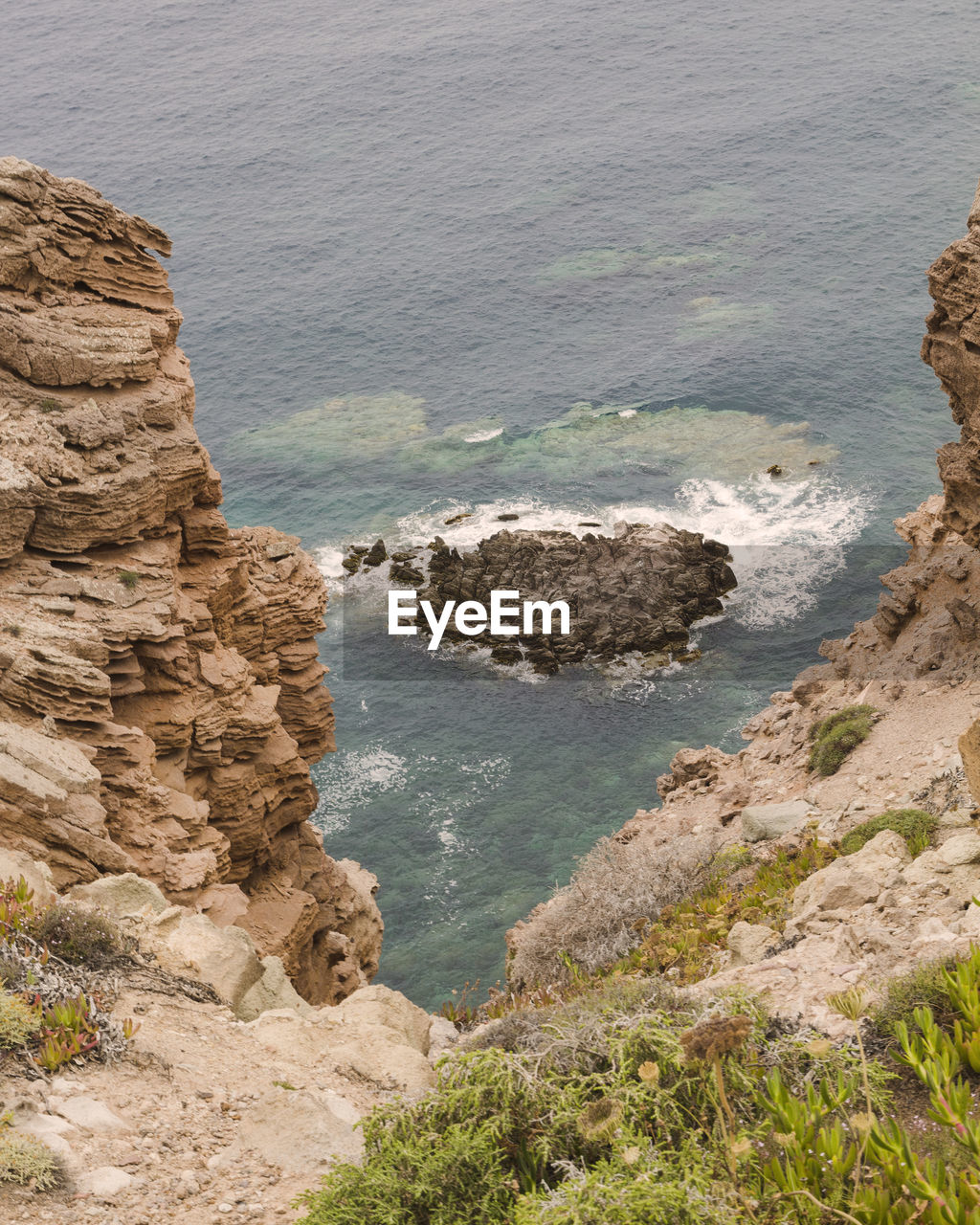 High angle view of rocks at sea shore