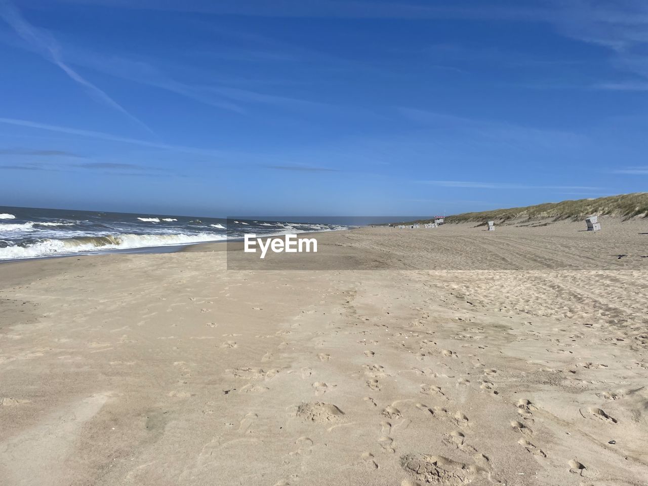 land, beach, sea, sand, sky, water, scenics - nature, nature, beauty in nature, environment, tranquility, natural environment, landscape, blue, coast, body of water, tranquil scene, horizon, shore, ocean, no people, day, travel destinations, cloud, horizon over water, non-urban scene, coastline, outdoors, wave, travel, dune, footprint, water's edge, clear sky, motion, tourism, sand dune, wind wave, holiday, trip, vacation, sunlight, idyllic, summer